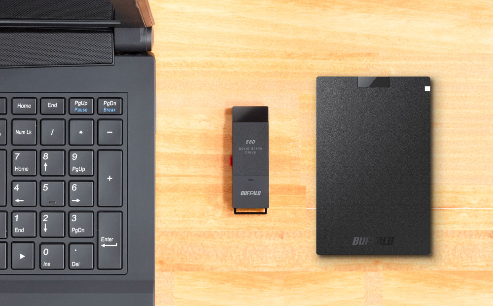 buffalo ssd pg and ssd put next to a black laptop with wood background